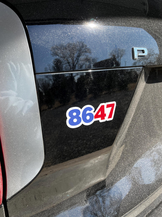 8647 magnet displayed on the back of a car, symbolizing political resistance and the call to reject Trump.