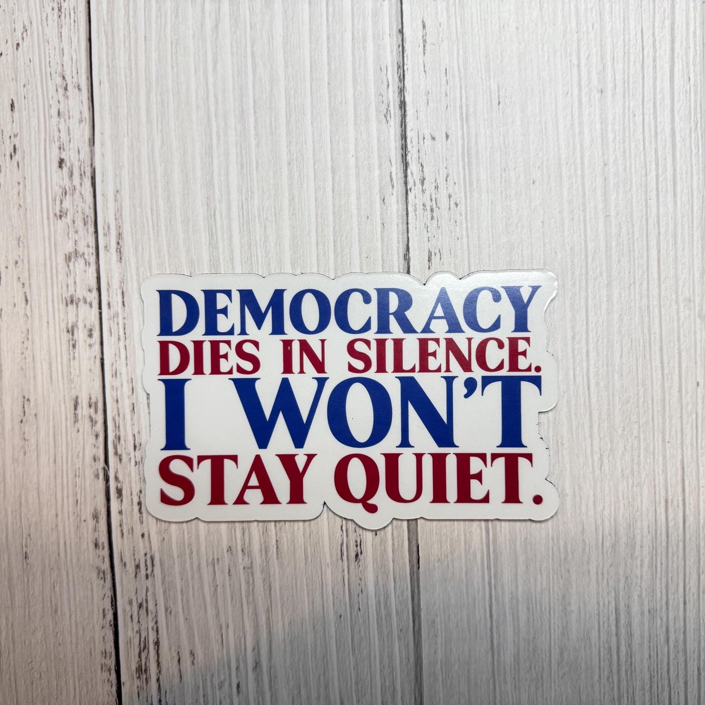 Democracy dies in silence. I won't stay quiet magnet shown on a table as a bold statement for justice and activism.