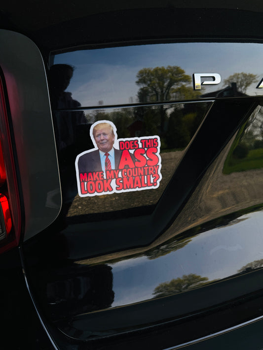 Does this ASS make my country look small magnet on the back of a car, using satire to critique Trump's political leadership.