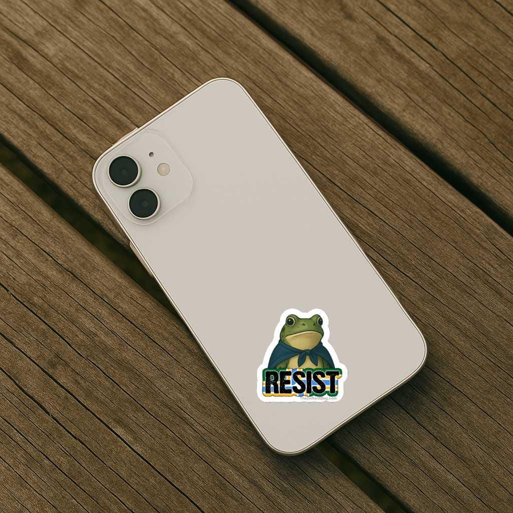 Phone case with a frog graphic and 'RESIST' text on a wooden surface