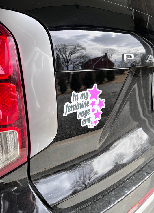 In My Feminine Rage Era magnet on the back of a car, expressing empowerment and unapologetic feminist energy.