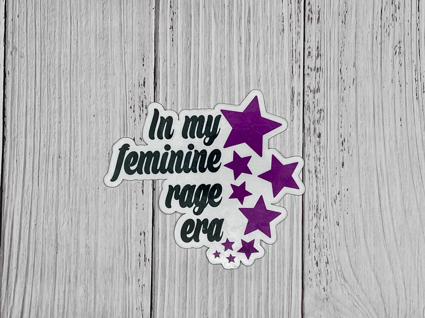 In My Feminine Rage Era magnet displayed on a table, celebrating bold feminism and activist spirit.