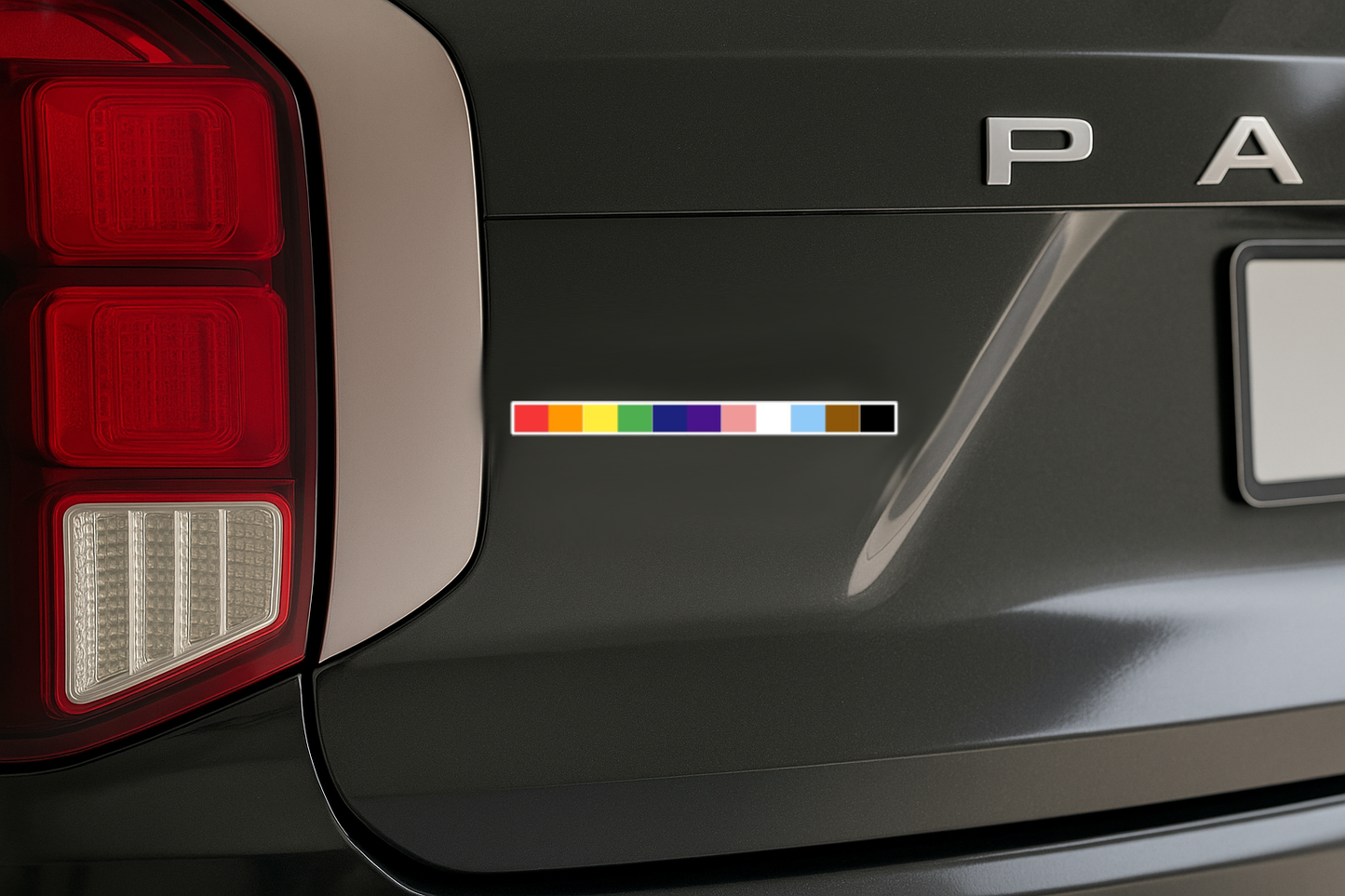 Pride rainbow bar magnet placed on the rear side panel of a black Hyundai Palisade near the taillight.