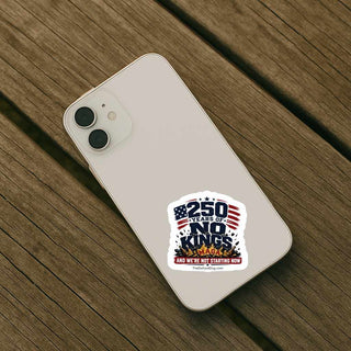 250 Years of No Kings political sticker displayed on the back of a white smartphone, featuring patriotic typography crushing a broken MAGA crown and the slogan And We’re Not Starting Now.