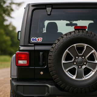 Sticker displaying the numbers “8647” on the rear window of a black Jeep