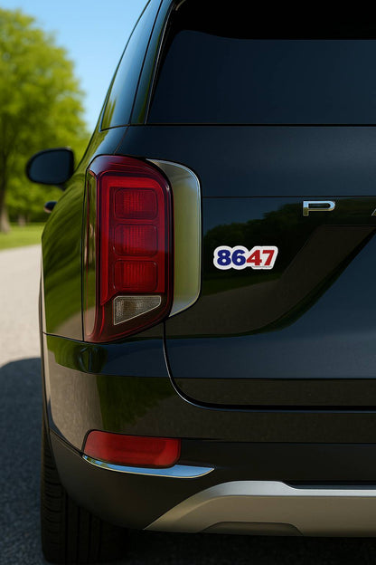 Sticker displaying the numbers “8647” on the rear of a black vehicle