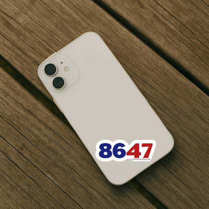 Sticker displaying the numbers “8647” on the back of a light-colored smartphone