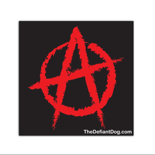 A square black patch or sticker featuring a distressed red anarchy symbol in the center, with small white text at the bottom reading TheDefiantDog.com, shown on a plain white background.