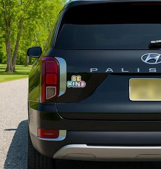 'Be Kind Sticker or' magnet or vinyl decal displayed on the back of a black SUV. A bold, high-quality political sticker perfect for cars, laptops, fridges, or toolboxes. Great for activists, protestors, or anyone fed up with fascism.
