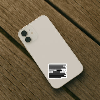 Phone case with 'Donald is in the Hill' text on a wooden surface