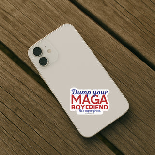 Phone with a "dump your maga boyfriend" sticker on a wooden surface