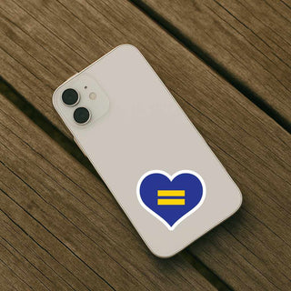 Phone case with a blue heart and yellow equality symbol on a wooden surface
