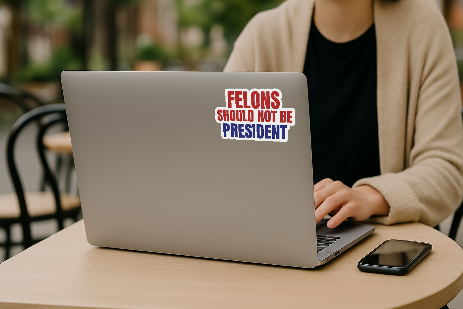 'Felons Should Not Be President' magnet or vinyl decal displayed on the back of a laptop. A bold, high-quality political sticker perfect for cars, laptops, fridges, or toolboxes. Great for activists, protestors, or anyone fed up with fascism.