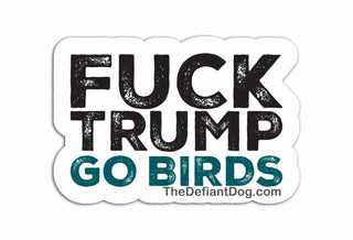 Sticker with text 'FUCK TRUMP GO BIRDS' and website 'TheDefiantDog.com' on a white background