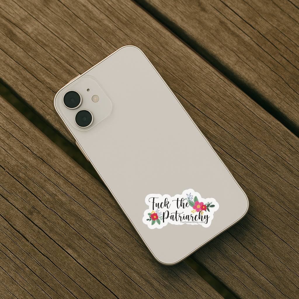 Phone case with 'Fuck the Patriarchy' sticker on a wooden surface