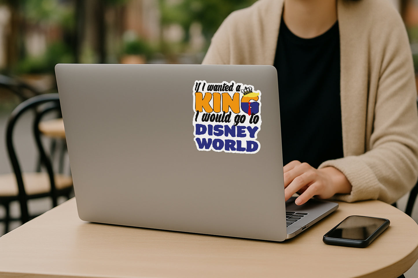 'If I Wanted a King I'd Go to Disney World' magnet or vinyl decal displayed on the back of a laptop. A bold, high-quality political sticker perfect for cars, laptops, fridges, or toolboxes. Great for activists, protestors, or anyone fed up with fascism.