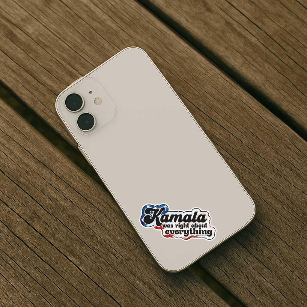 White smartphone with a sticker on a wooden surface