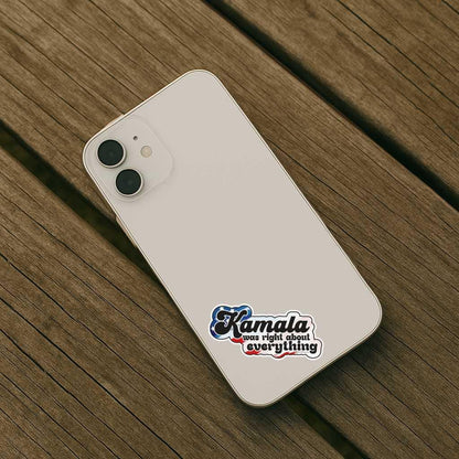 White smartphone with a sticker on a wooden surface