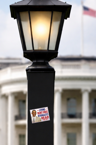 Barack Obama political sticker featuring the Living Rent Free Since 2008 slogan on a black lamppost near the White House.