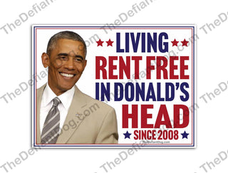 Barack Obama Living Rent Free in Donald's Head Since 2008 political yard sign featuring Obama's tan suit, smiling portrait, patriotic stars and bold red and blue lettering.