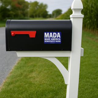 Blue and white sticker with 'MADA Make America Democratic Again' text on a black mailbox