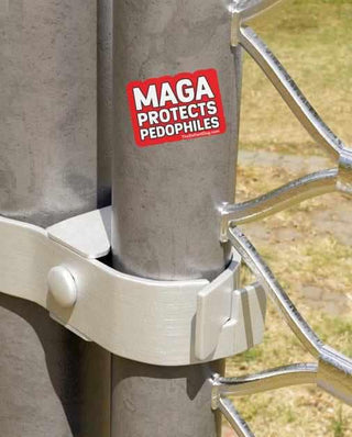Sticker on a metal pole with text 'MAGA Protects Pedophiles' against a blurred outdoor background.