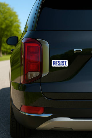 Black car with 'RESIST' sticker on the back