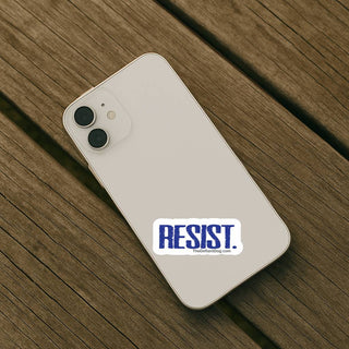 Phone with 'RESIST' sticker on a wooden surface
