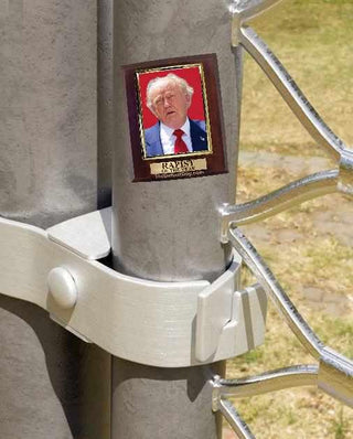 Metallic object with a small framed picture of a Donald Trump on it