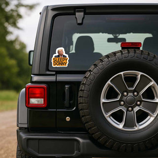 Black Jeep with a 'Sleepy Donny' sticker on the rear window