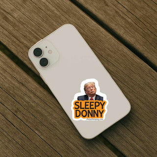 Phone case with 'Sleepy Donny' sticker on a wooden surface