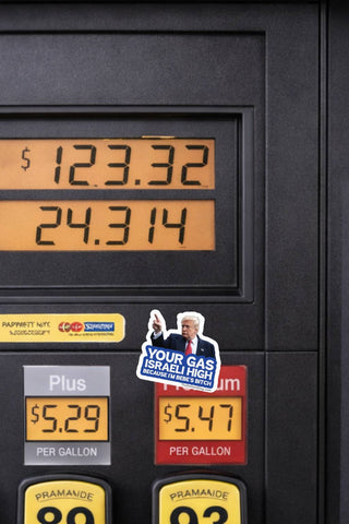 Funny anti-Trump gas prices political sticker on a black gas pump beside fuel price displays, featuring Donald Trump pointing and Your Gas Israeli High Because I'm Bebe's Bitch lettering.