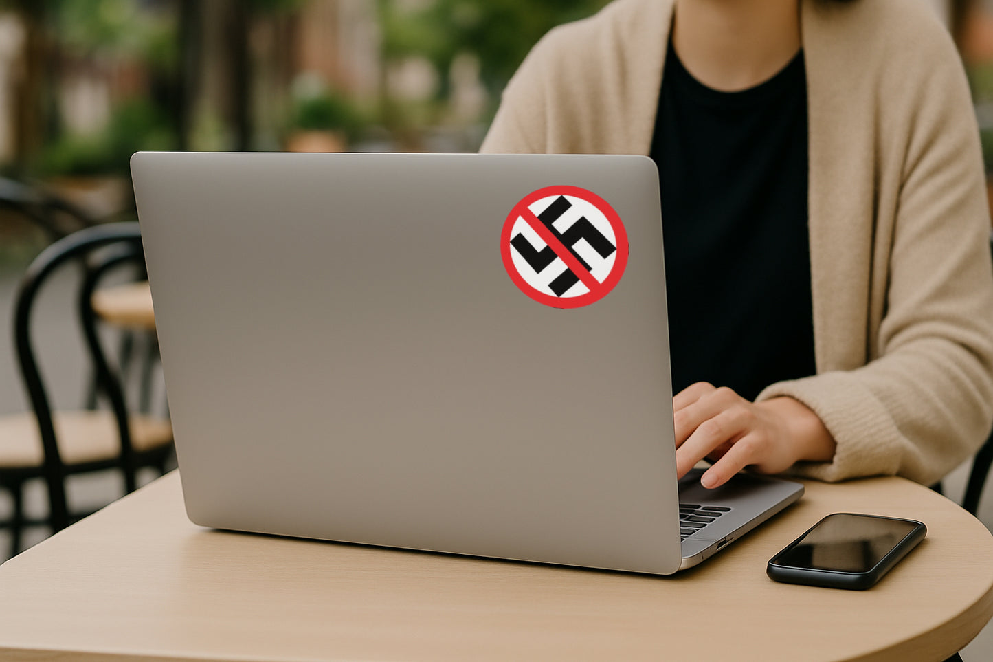 'Anti-Nazi' magnet or vinyl decal displayed on the back of a laptop. A bold, high-quality political sticker perfect for cars, laptops, fridges, or toolboxes. Great for activists, protestors, or anyone fed up with fascism.