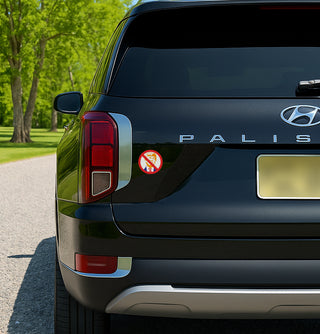 'Anti-Trump MAGA Red Circle with Line Through It' magnet or vinyl decal displayed on the back of a black SUV. A bold, high-quality political sticker perfect for cars, laptops, fridges, or toolboxes. Great for activists, protestors, or anyone fed up with fascism.