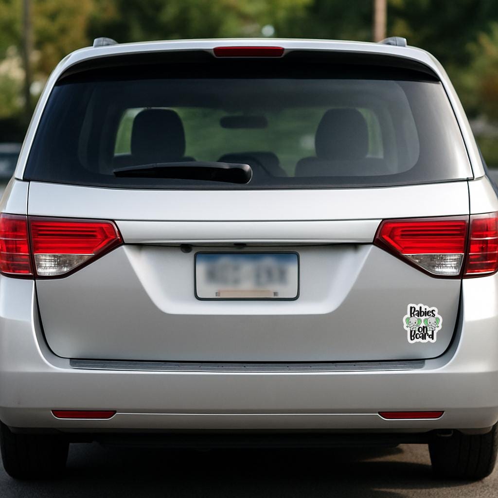 back of silver minivan with babies on board magnet on tailgate