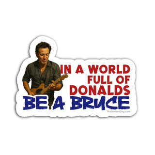 Sticker with a graphic of a person playing guitar and text 'In a world full of Donalds be a Bruce' on a white background.