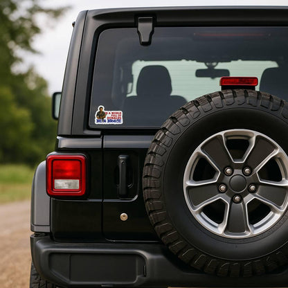 Sticker with a graphic of a Bruce Springsteen playing guitar and text 'In a world full of Donalds be a Bruce' on the window of a jeep wrangler