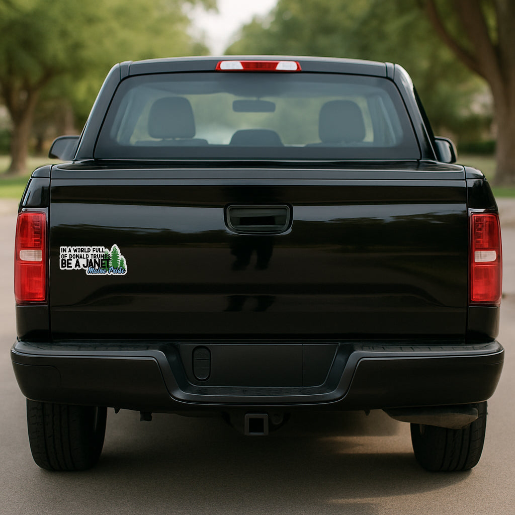 'In a World of Donald Trumps Be a Janet' magnet or vinyl decal displayed on the tailgate of a black pickup truck. A bold, high-quality political sticker perfect for cars, laptops, fridges, or toolboxes. Great for activists, protestors, or anyone fed up with fascism.
