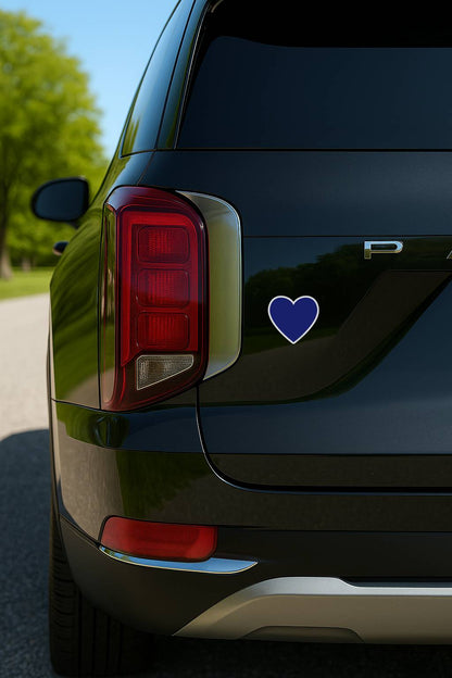 Black car with a blue heart-shaped decal on the back