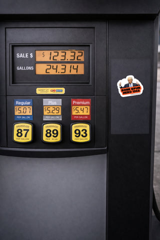 Close-up of a dark gray fuel pump display showing sale price, gallons, and three fuel grade buttons labeled Regular 87, Plus 89, and Premium 93, with a small 'Home Station Brand Sticker' on the right side.