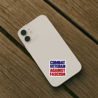 Phone case with 'Combat Veteran Against Fascism' text on a wooden surface