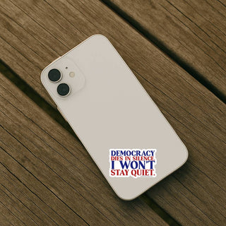Light colored smartphone case displaying Democracy Dies In Silence I Won’t Stay Quiet vinyl sticker near bottom