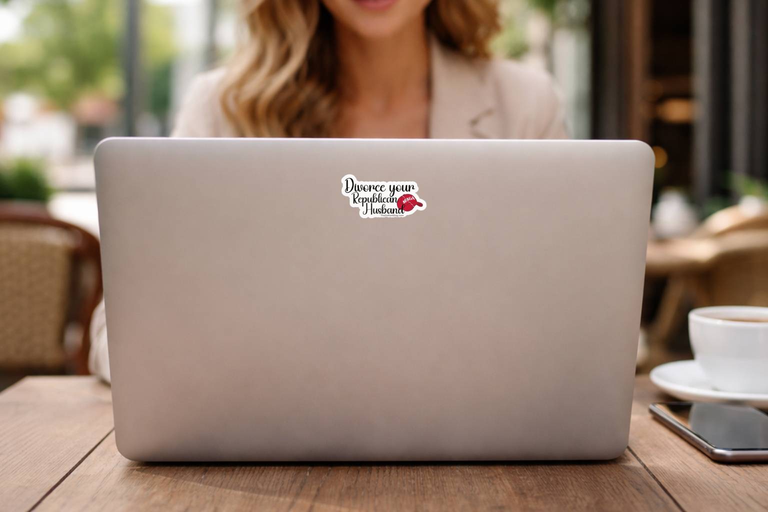 Silver laptop with Divorce Your Republican Husband political vinyl sticker centered on lid