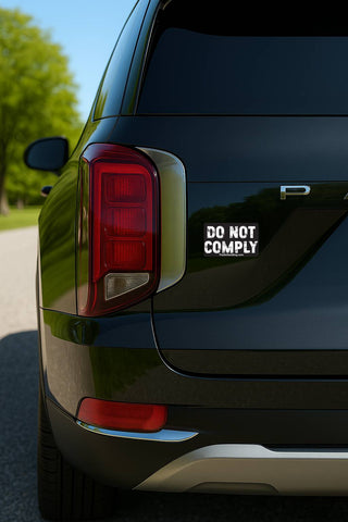 Black car with 'DO NOT COMPLY' sticker on the back