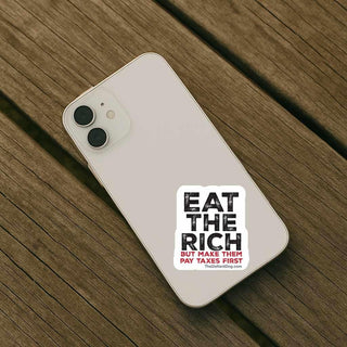 Phone with a sticker on a wooden surface