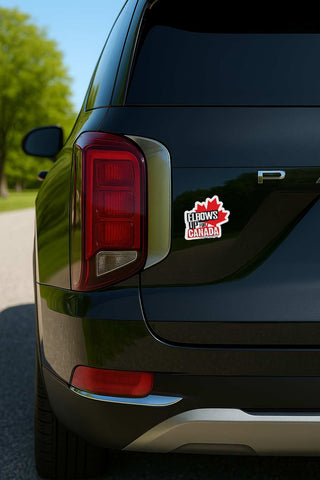 A close-up rear view of a black SUV parked outdoors, showing a red and white 'I Love My Canada' maple leaf decal applied to the quarter panel.