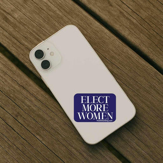 Phone with 'Elect More Women' sticker on a wooden surface
