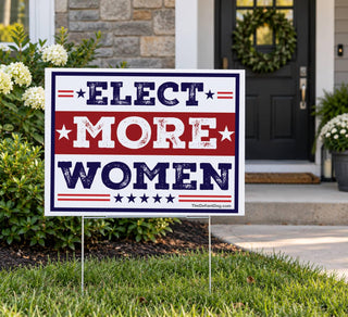 Elect More Women feminist political yard sign displayed on a lawn in front of a house with red white and blue vintage campaign-style design.