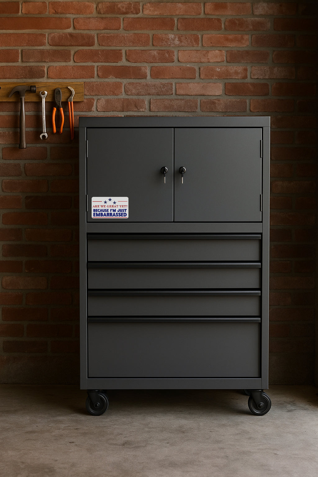 Are We Great Yet? Because I'm Just Embarrassed' magnet or vinyl decal displayed on a black tool cabinet. A bold, high-quality political sticker perfect for cars, laptops, fridges, or toolboxes. Great for activists, protestors, or anyone fed up with fascism.