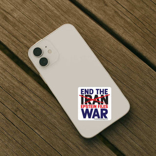 A white smartphone case with a political graphic sticker, shown from the back on a dark brown wooden plank surface. The sticker reads 'END THE IRAN EPSTEIN FILES WAR' with 'IRAN' crossed out in red.